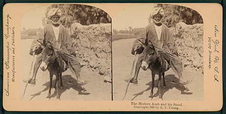 Black-and-white Photograph of a Man Mounted on a Donkey